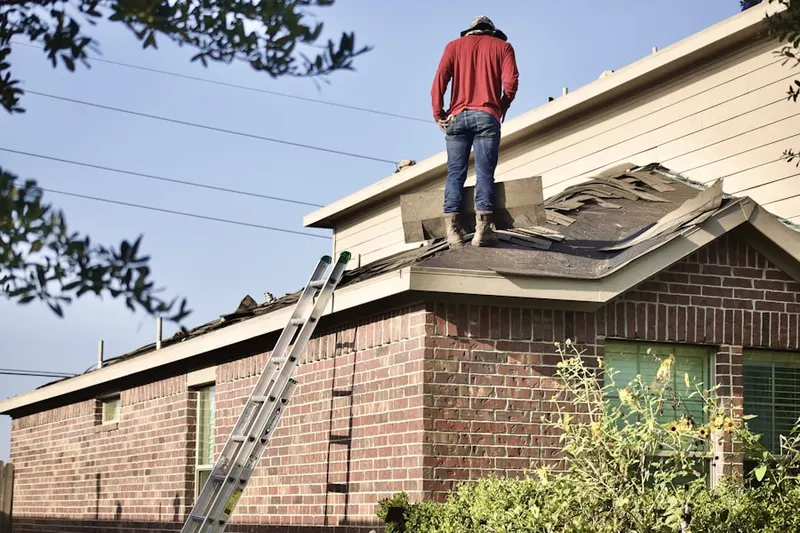 Professional roofer working on a residential roof in Westwood Lake